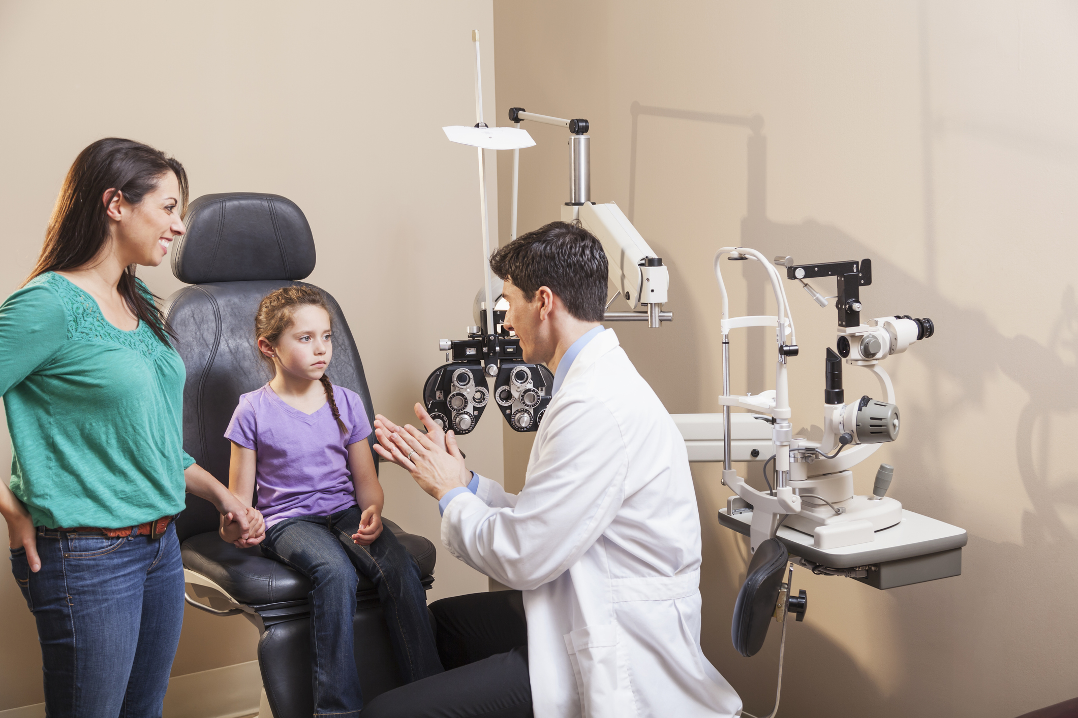 Girl with mother visiting eye doctor