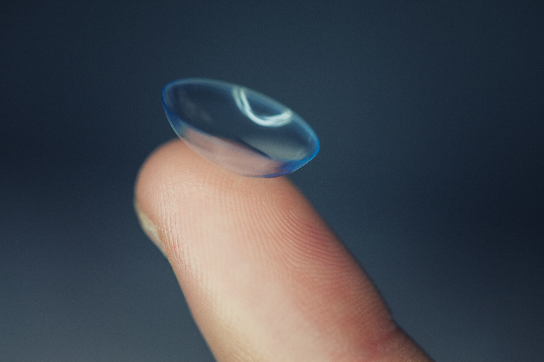 Closeup of contact lens on finger