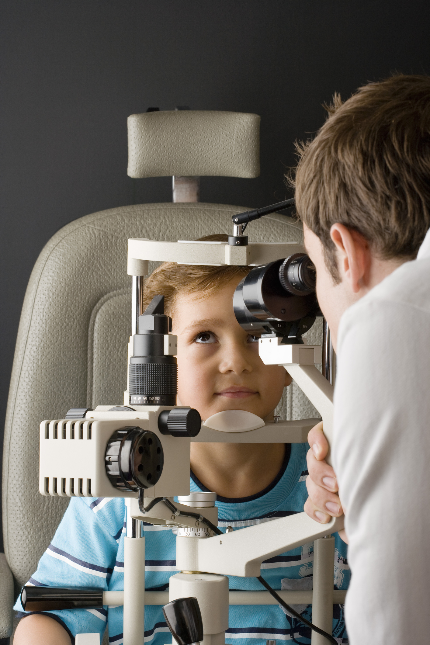 Man looking at eye with slit lamp
