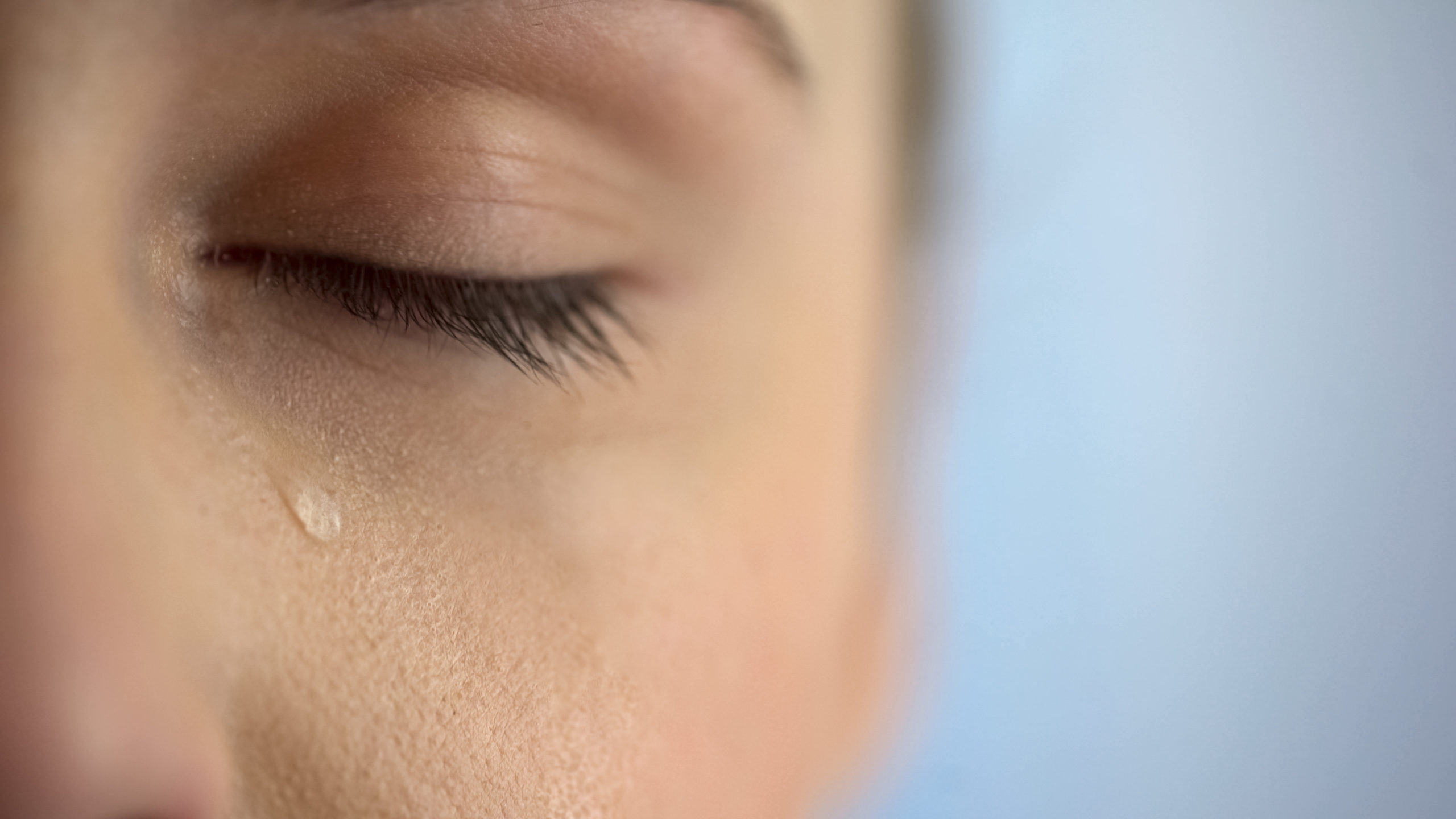 Face of unhappy woman crying, closeup eye with teardrops, life problems anguish