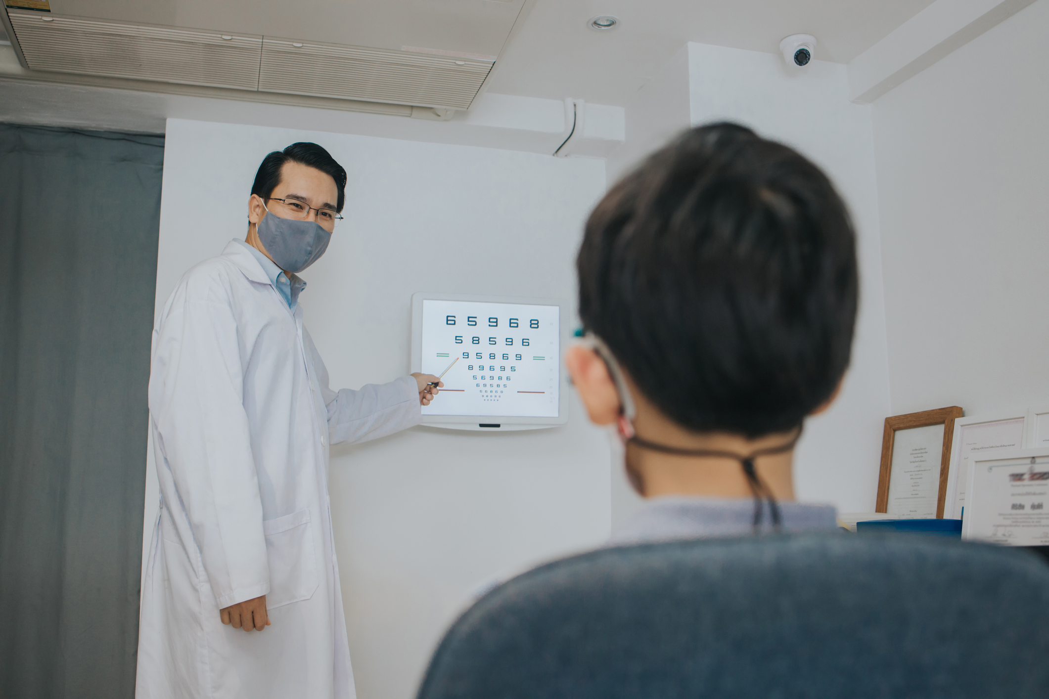 Ophthalmologist man working while covid19 spread-stock photo