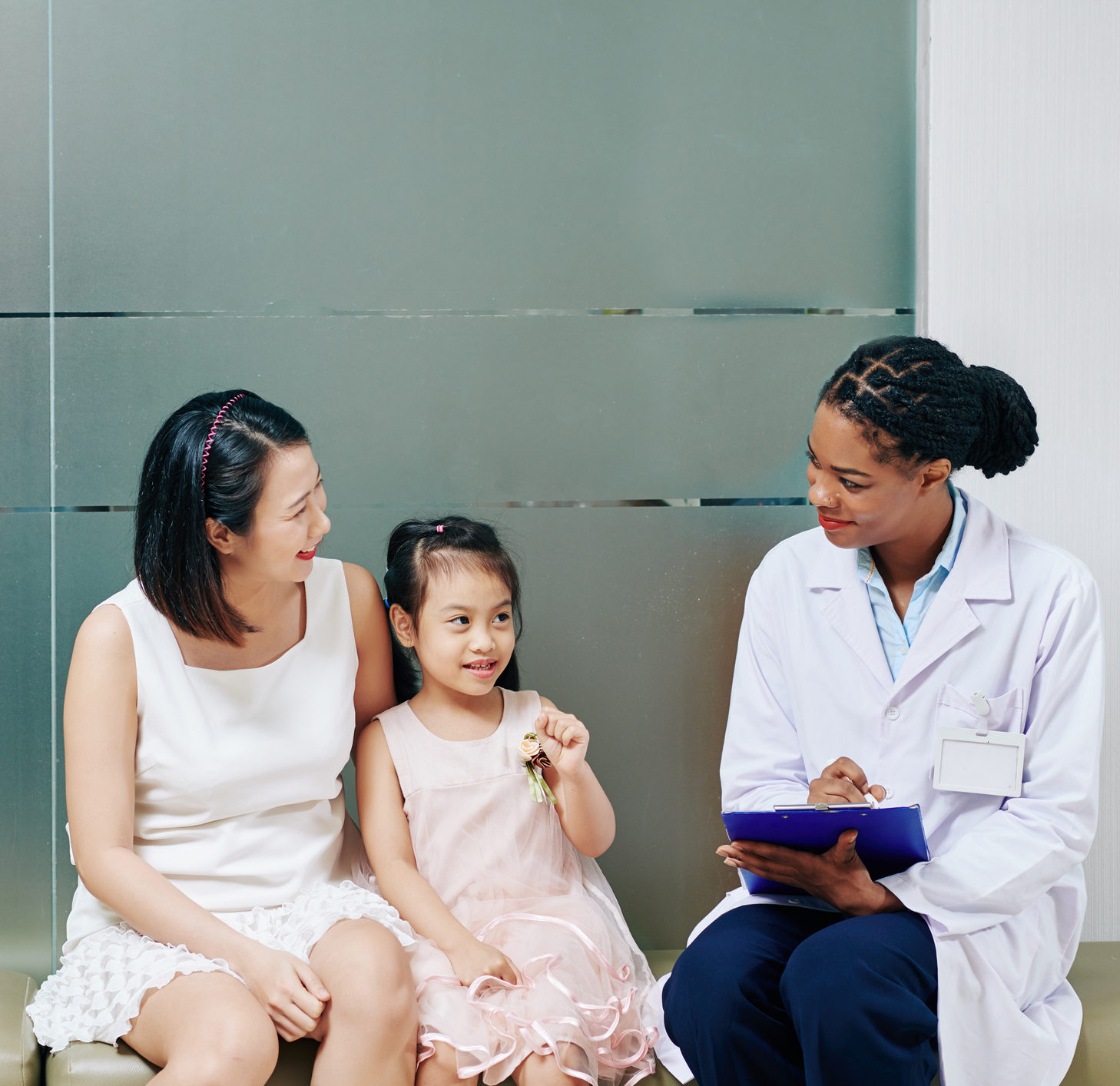 Pediatrician talking to little girl