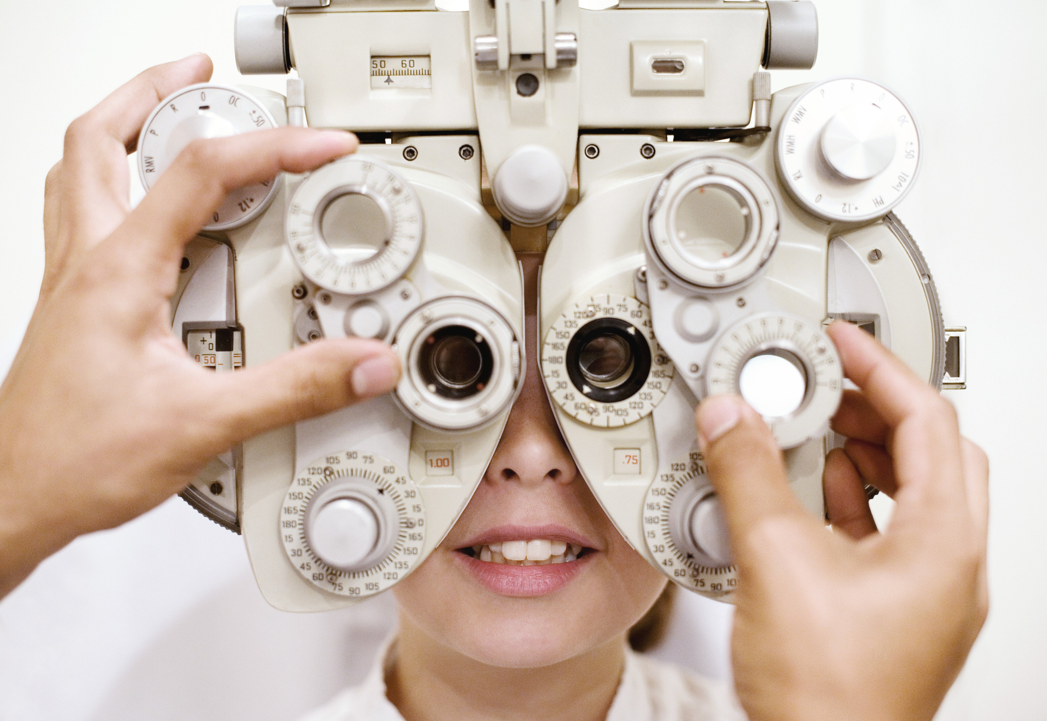 Optometrist (optician) examining eye of woman