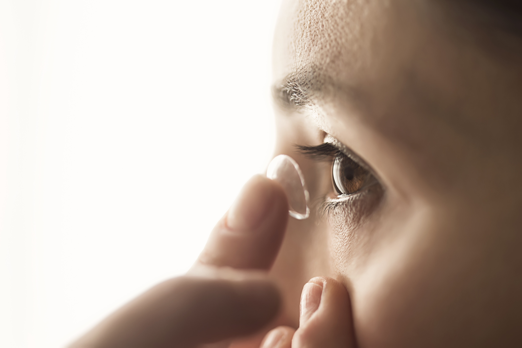 Woman using a contact lens