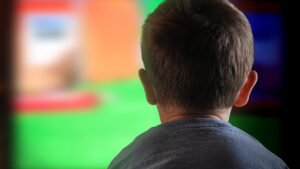 A photo of a child staring at a screen, indicating digital screen time