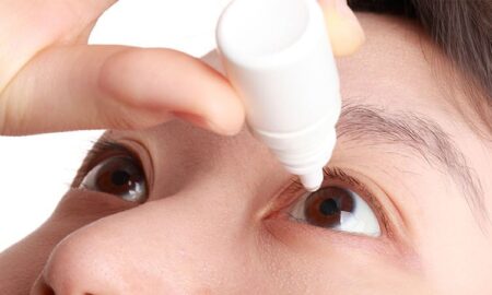 An image of a child inserting eye drops