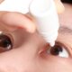 An image of a child inserting eye drops