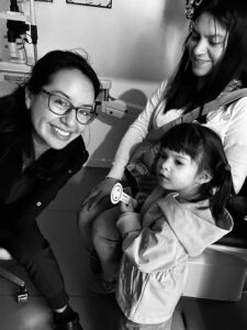 Dr. Damaris Raymondi with a young patient from her practice