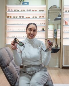 Dr. Bilkhu holding glasses.