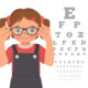 Cartoon of little girl who is wearing glasses and standing in front of an eye test