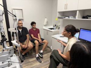 Dr. Vishakha Thakrar explains the value of myopia management to a young patient and his father.
